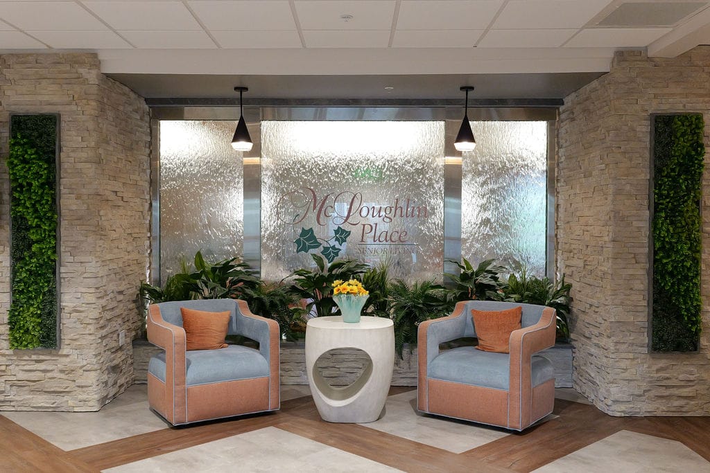 Lobby water feature with the McLoughlin Place mark etched into the glass panel