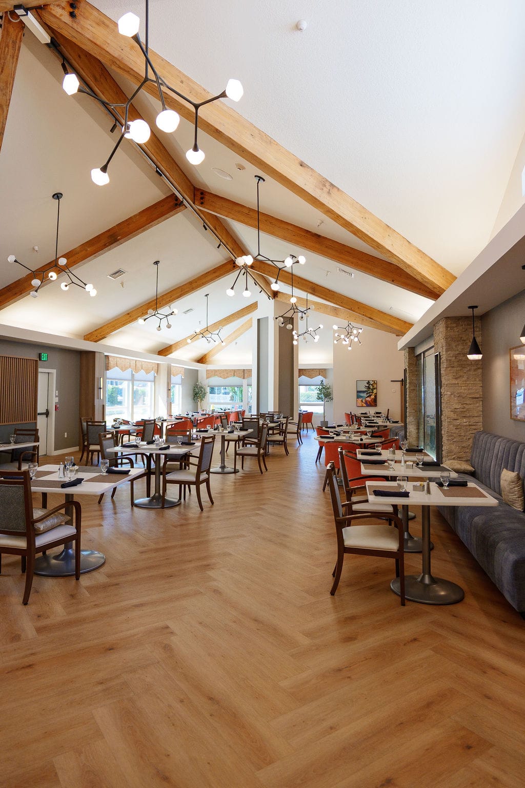 Dining room photographed vertically up into the exposed wooden roof beams