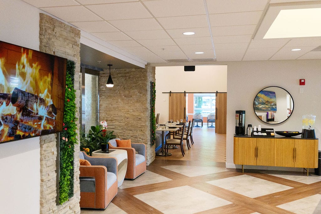 Lobby with a wall-mounted fireplace and a coffee station alongside it
